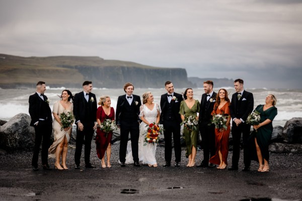 Bride groom groomsmen best man bridesmaids in front of scenic sea Kerry mountains and clifftop