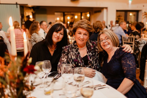 Three women guests smile for the camera