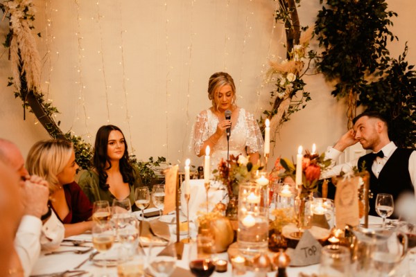 Bride is emotional as she speaks into microphone during speech