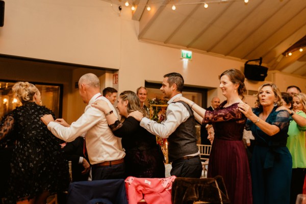 Trail of partygoers dancing on the dancefloor guests