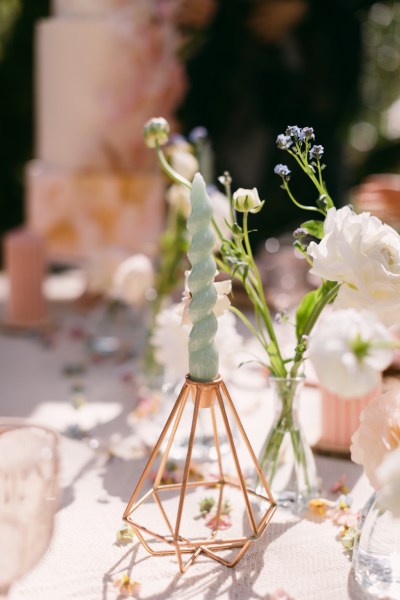 White rose flower on table in vase and candle