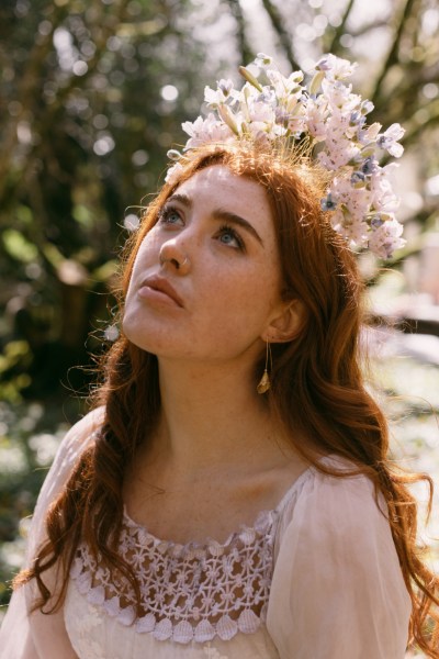 Ruby Rose in forest floral headband trees close up