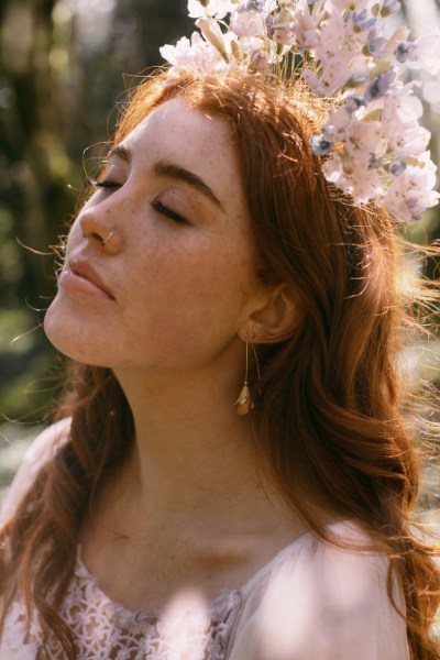 Ruby Rose in forest floral headband trees close up