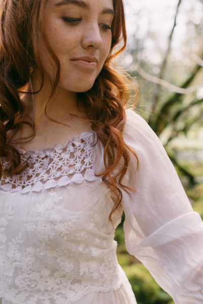 Hair detail wavy red head model bride looking down