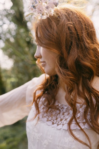 Hair detail wavy red head model bride looking away from camera