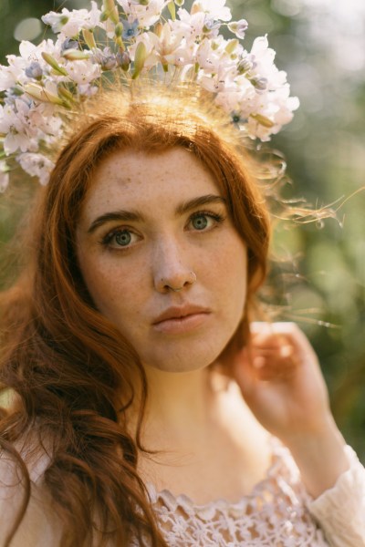 Model bride close up red head wearing floral flower headband