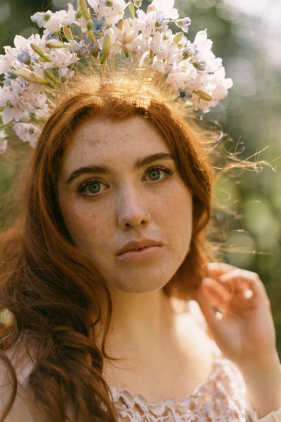 Model bride close up red head wearing floral flower headband