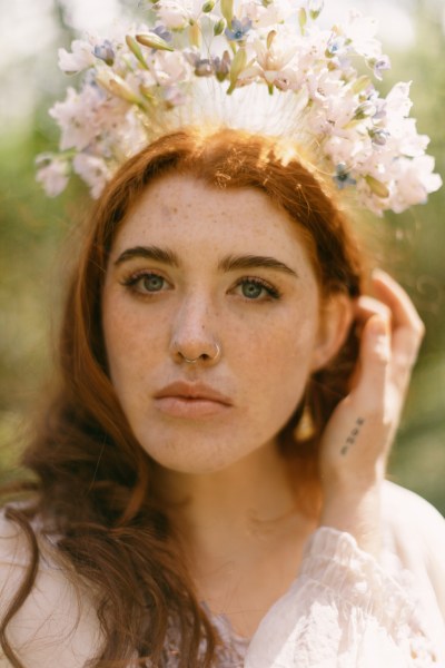 Model bride close up red head wearing floral flower headband