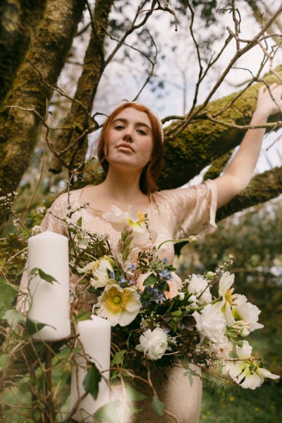 Ruby Rose in forest covered in flowers trees bouquet