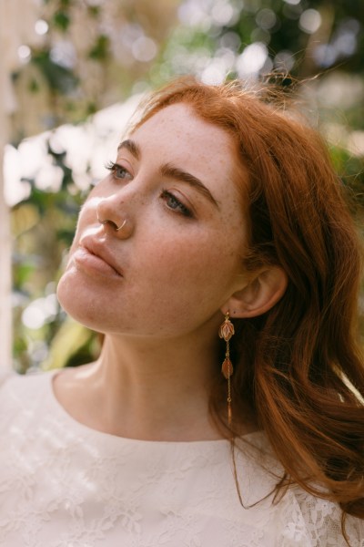 Close up of red headed bride woman model earrings