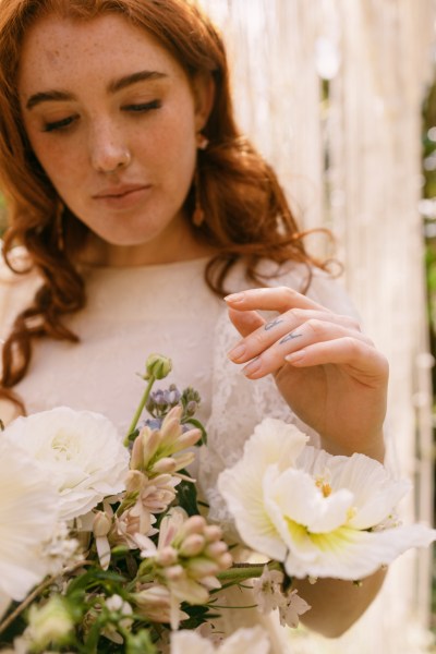 Close up of model brides hand tattoo sunflower yellow white