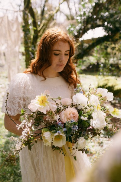 Close up of yellow white sunflowers model bride poses red headed sunshine