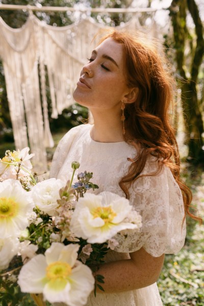 Close up of yellow white sunflowers model bride poses red headed sunshine