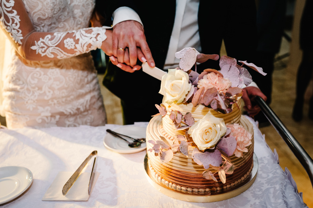 bride and groom cutting wedding cake