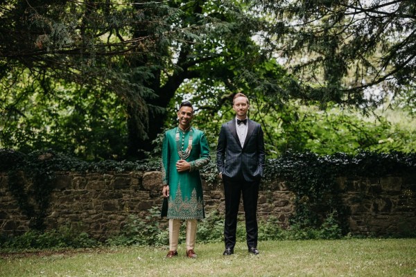 Grooms in garden tree in background and wall