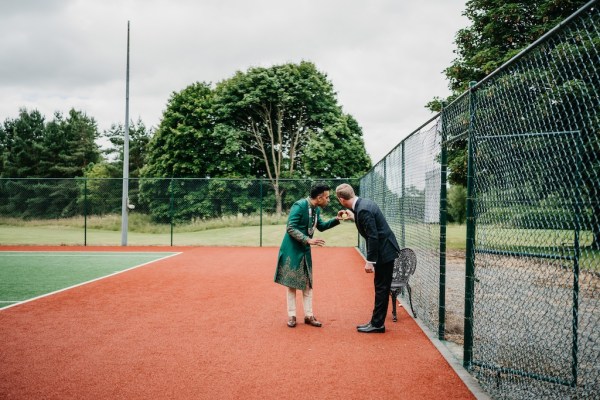 Groom in tennis courtyard