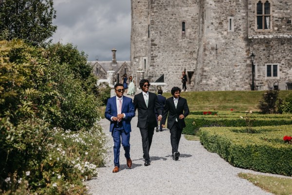 Guests walk towards the ceremony in sunshine