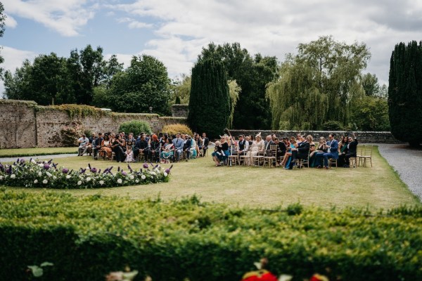 Guests seated awaiting arrival of groom and groom