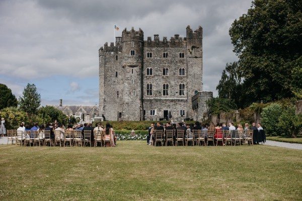 Guests seated awaiting arrival of groom and groom castle shot view