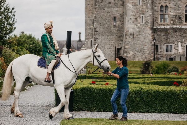 Groom on white horse makes entrance