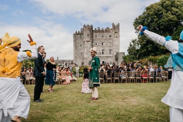 Grooms surrounded by guests and dancers