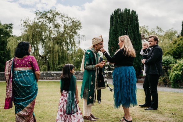 Woman in blue skirt and groom with little girl