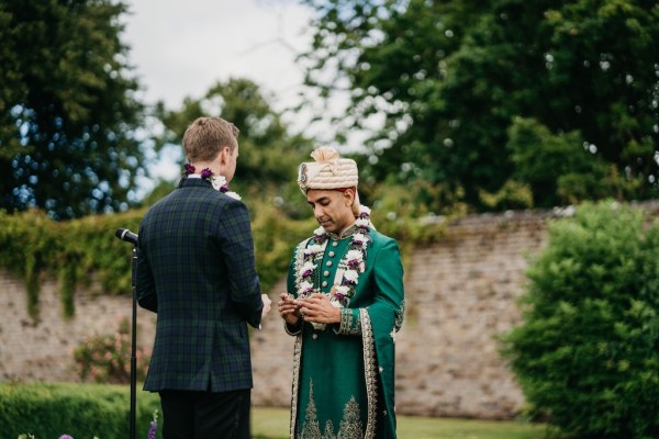 Grooms during ceremony at alter microphone