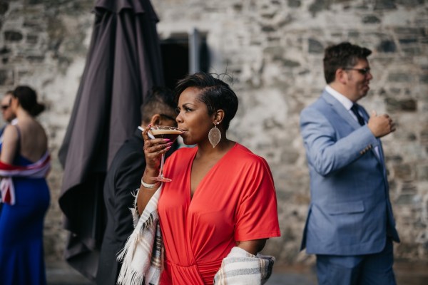 Woman wearing red dress drinking cocktail