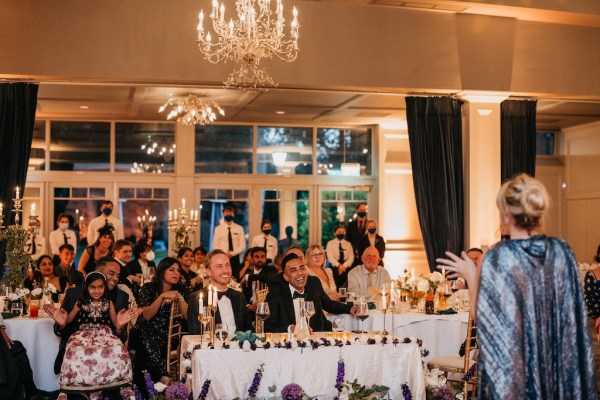 Grooms sit and laugh during dining room experience