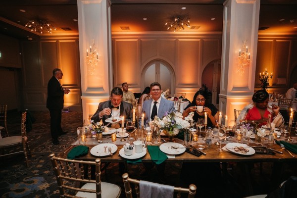 Guests at dining table enjoying food and drink