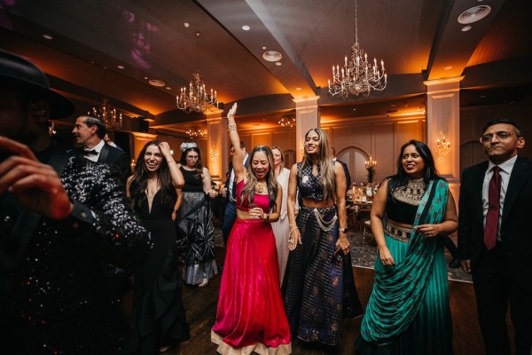 Groom on dancefloor surrounded by guests