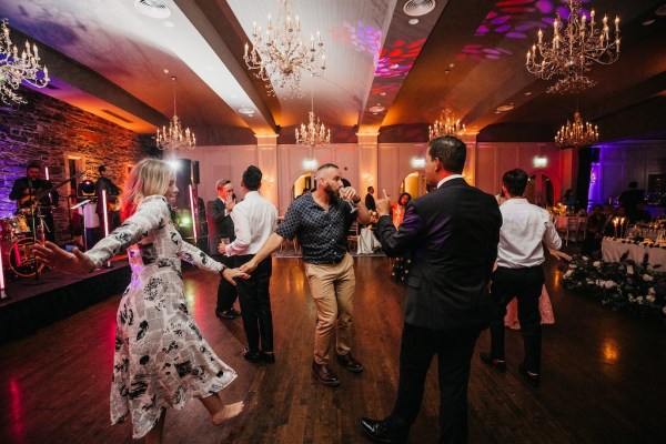 Groom on dancefloor with friends