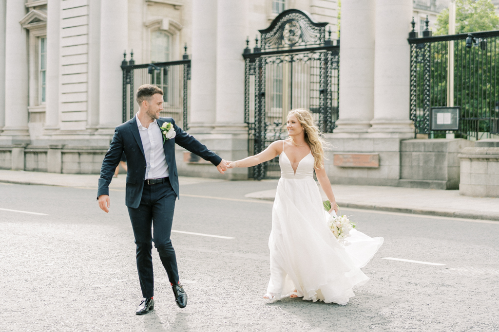 Bride and groom cross the street