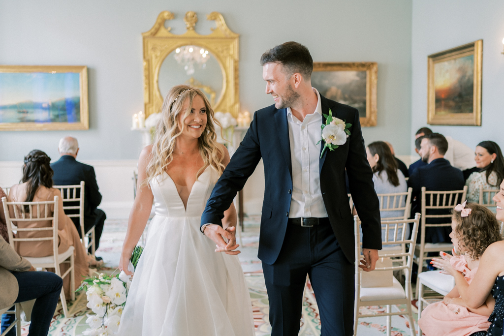 Bride and groom are pronounced husband and wife as they exit ceremony holding hands