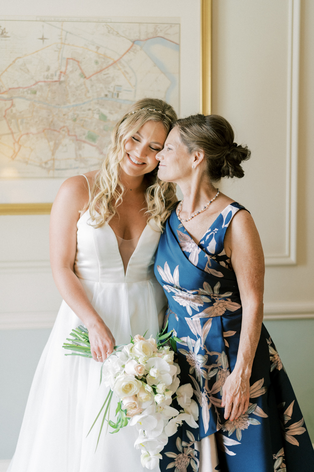 Mother and daughter smile together in room