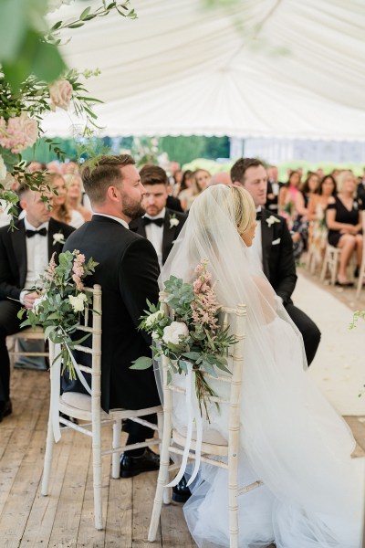 Bride groom and guests seated