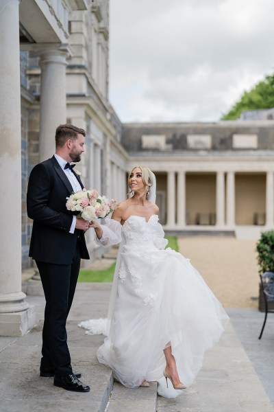 Bride and groom walk down the steps