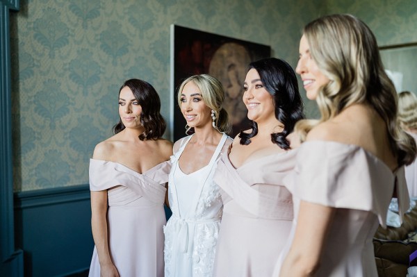 Bride and her bridesmaids pose together