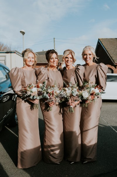 Four bridesmaids holding bouquet/flowers