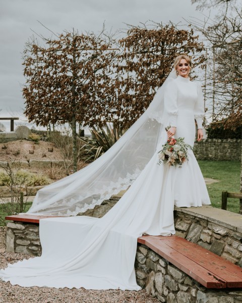 Bride standing on steps in garden