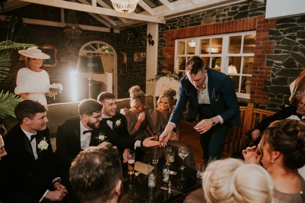 Group of men and women seated pub setting