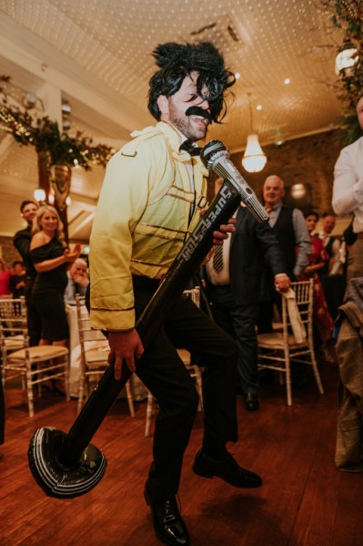 Moustache singer rockstar singing into microphone