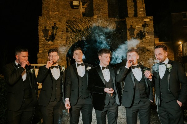 Groom and groomsmen posing together