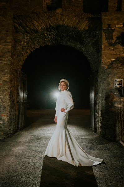 Bride at night darkened shot posing hand on hip