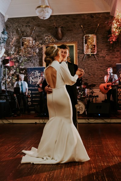 Bride and groom enjoy their first dance on dancefloor