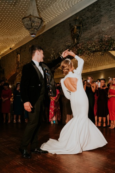 Bride and groom enjoy their first dance on dancefloor