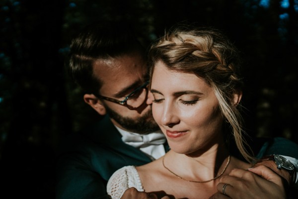 Dark photography of couple smiling bride and groom embrace