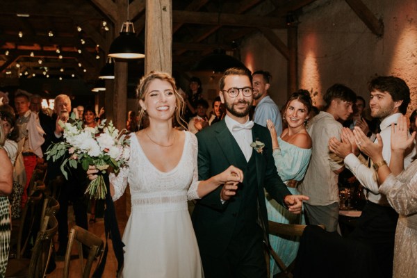 Bride and groom embrace on the dancefloor dance and smile