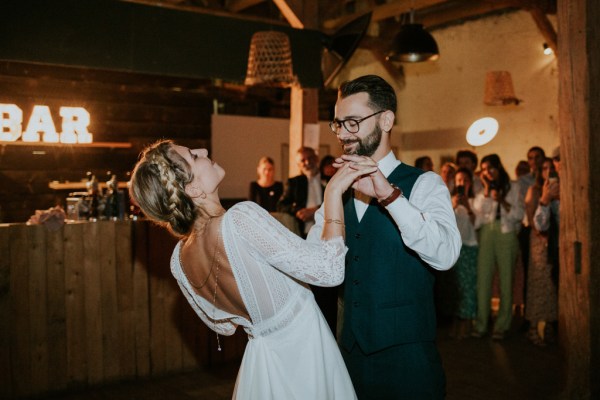 Bride and groom embrace on the dancefloor dance and smile