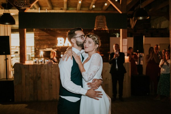 Bride and groom embrace on the dancefloor